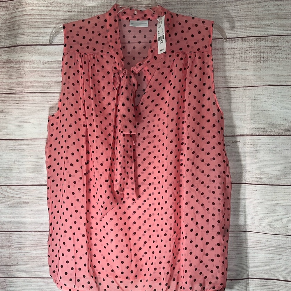 Polka dot sleeveless New York & Co sheer blouse with a tie accent in the front.